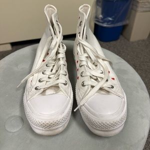 White platform converse with red hearts.